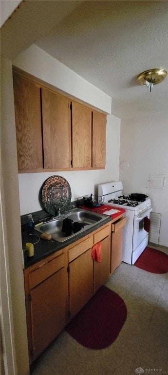 kitchen with sink and white gas range oven