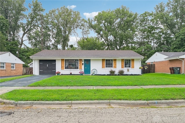 single story home featuring a front lawn and a garage