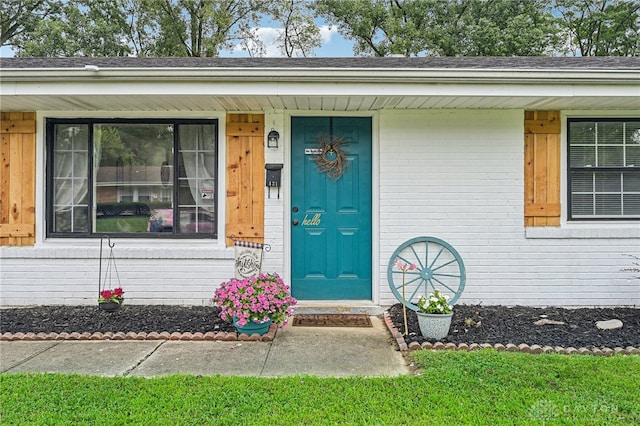 view of exterior entry with covered porch