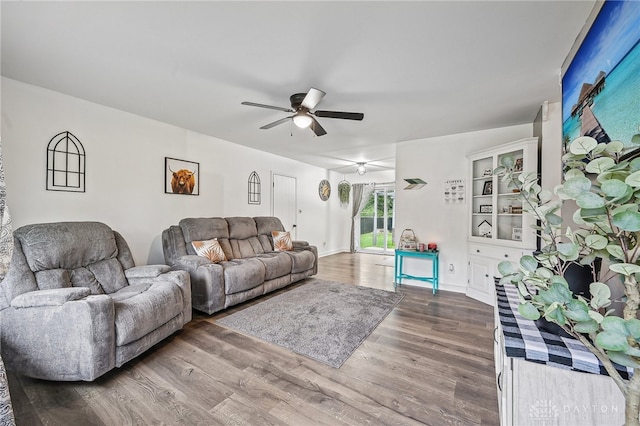 living room featuring ceiling fan and hardwood / wood-style flooring