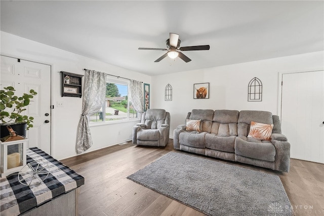 living room with hardwood / wood-style flooring and ceiling fan