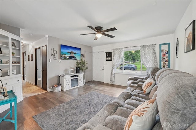 living room with hardwood / wood-style floors and ceiling fan