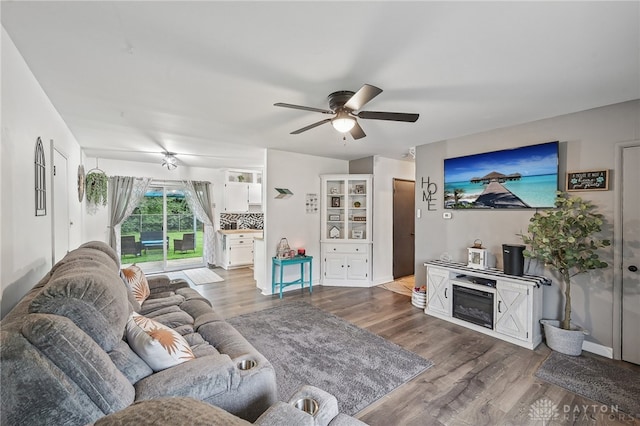 living room featuring ceiling fan and hardwood / wood-style flooring