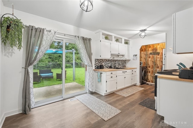 kitchen featuring white cabinets, tasteful backsplash, sink, and hardwood / wood-style floors