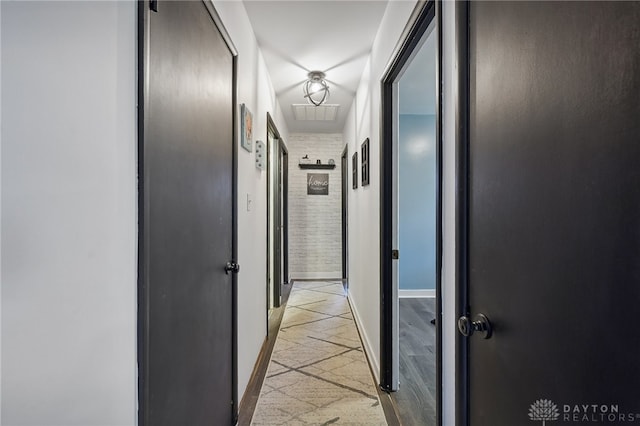 hall with light tile patterned floors