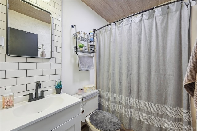 bathroom featuring tasteful backsplash, vanity, tile walls, wood ceiling, and toilet