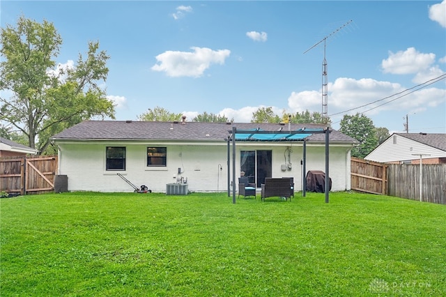 back of house with a lawn and central AC unit