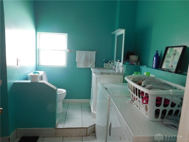 bathroom with vanity, toilet, tile patterned floors, and washing machine and clothes dryer