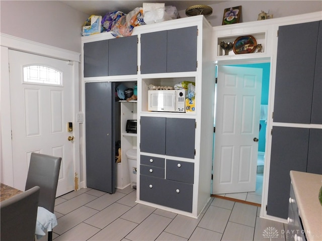 kitchen featuring gray cabinets and light tile patterned floors