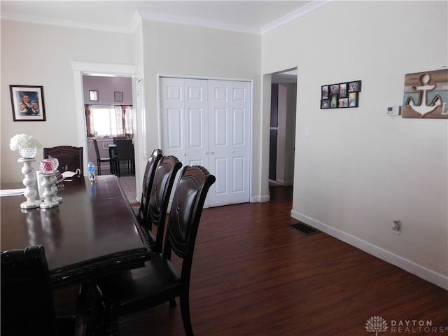 dining space with crown molding and hardwood / wood-style flooring