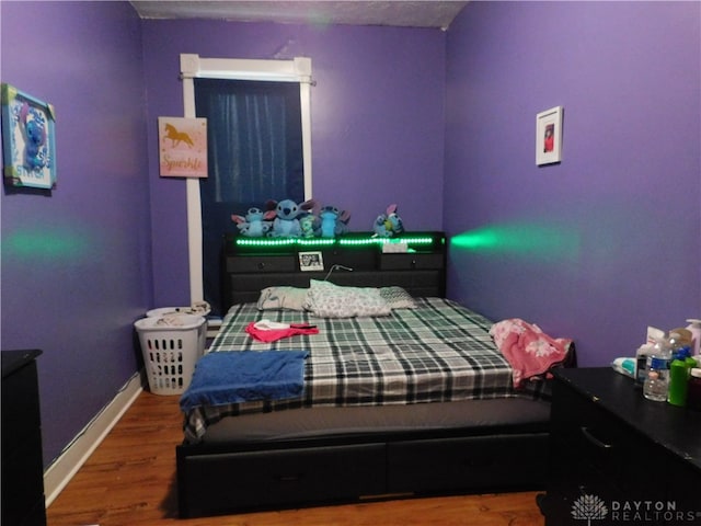 bedroom with hardwood / wood-style floors