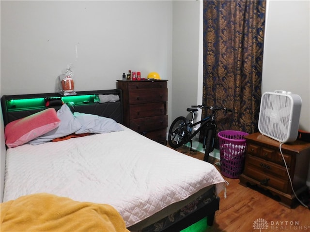 bedroom with hardwood / wood-style flooring