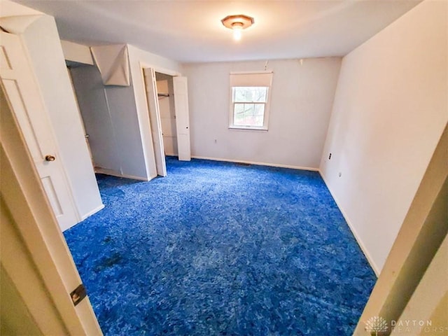 unfurnished bedroom featuring dark colored carpet