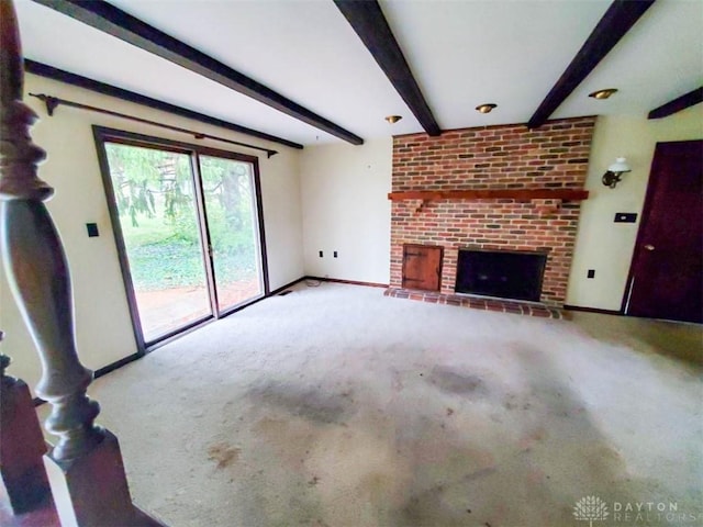 unfurnished living room featuring light colored carpet, a fireplace, and beam ceiling