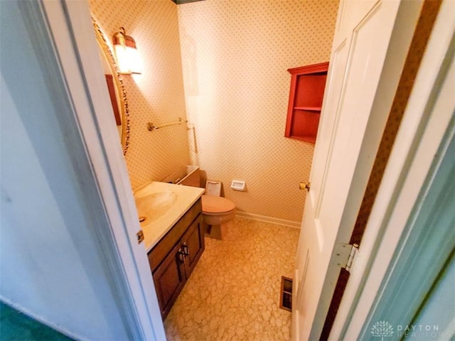 bathroom with vanity and toilet