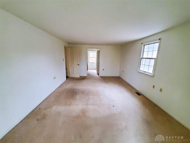 carpeted empty room with plenty of natural light