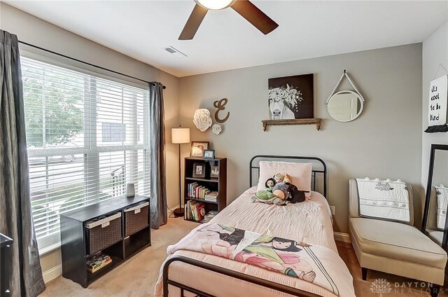 bedroom featuring light carpet and ceiling fan