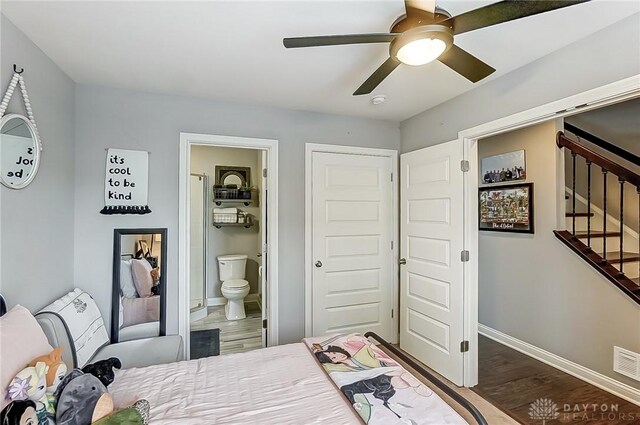 bedroom with a closet, wood-type flooring, ceiling fan, and connected bathroom