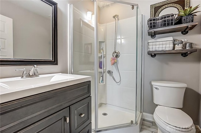 bathroom with vanity, an enclosed shower, and toilet