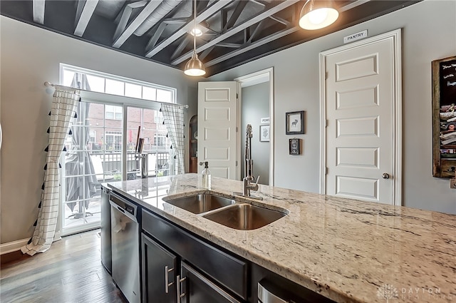 kitchen featuring light wood-type flooring, dishwasher, light stone counters, beamed ceiling, and hanging light fixtures