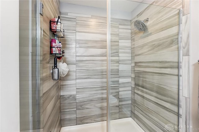 bathroom with a shower with shower door