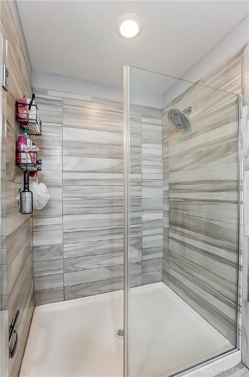 bathroom featuring a shower with door