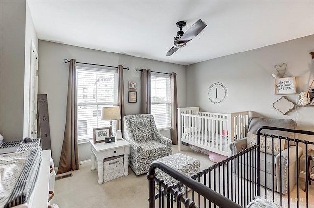 bedroom featuring light carpet and ceiling fan