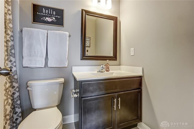 bathroom with toilet and vanity