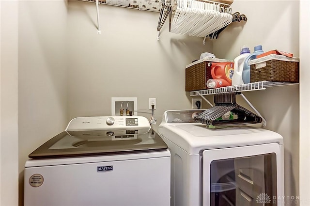 clothes washing area featuring washer and dryer