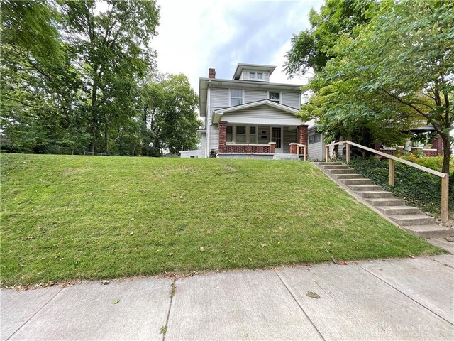 view of front of home featuring a porch and a front yard