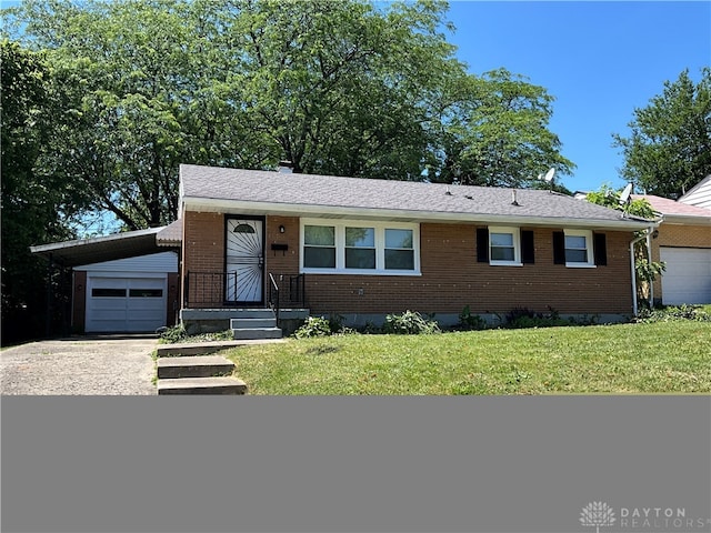 single story home featuring a garage and a front lawn