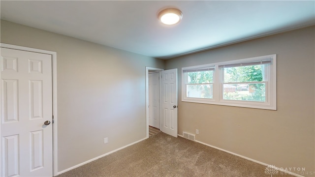 unfurnished bedroom with carpet flooring