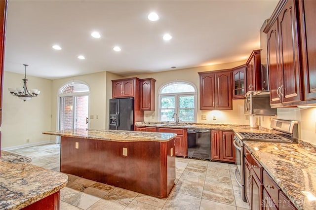 kitchen with black appliances, light tile patterned floors, and a center island