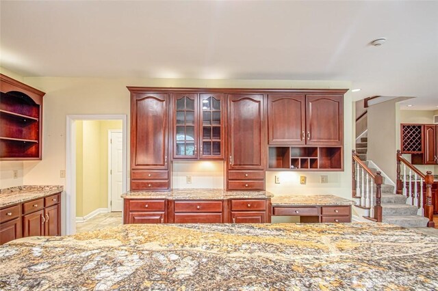 kitchen featuring tile patterned floors and light stone countertops