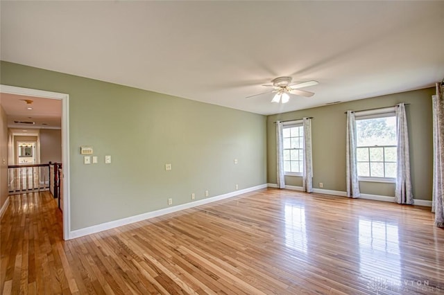 spare room featuring light wood-type flooring and ceiling fan