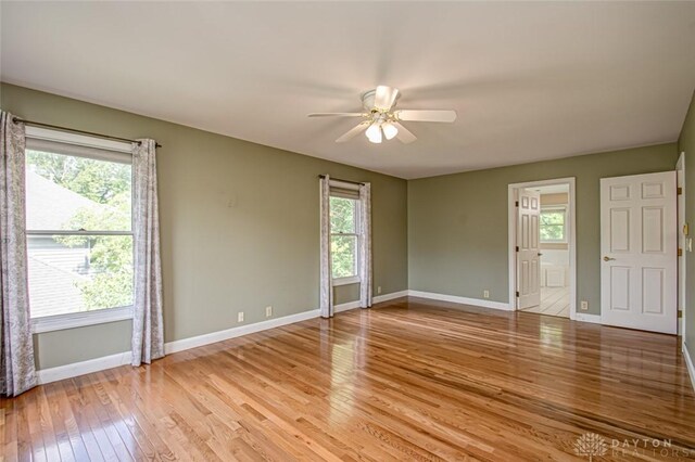 unfurnished room with light wood-type flooring and ceiling fan