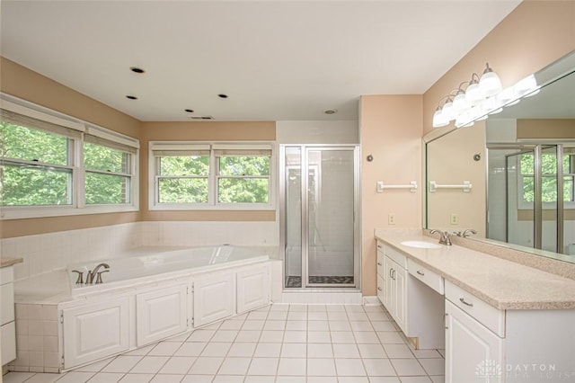 bathroom featuring vanity, shower with separate bathtub, and tile patterned floors