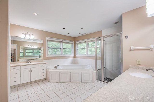 bathroom featuring tile patterned flooring, separate shower and tub, a wealth of natural light, and vanity