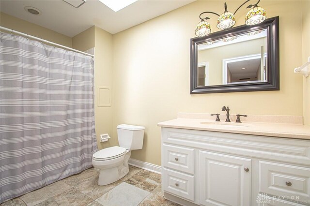 bathroom featuring tile patterned floors, toilet, and vanity