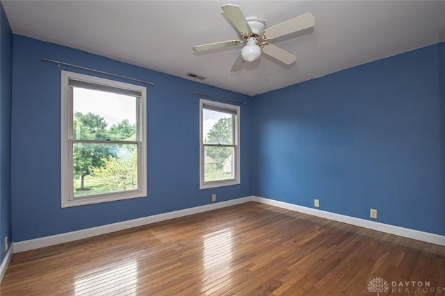 empty room with wood-type flooring and ceiling fan