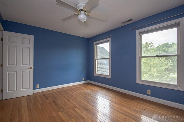 unfurnished room with wood-type flooring and ceiling fan