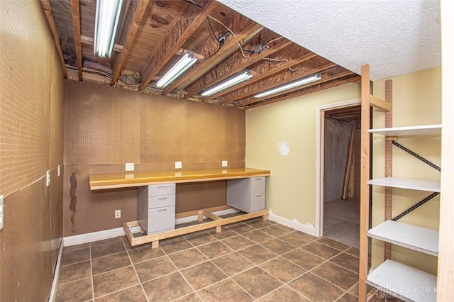 interior space featuring tile patterned floors and built in desk