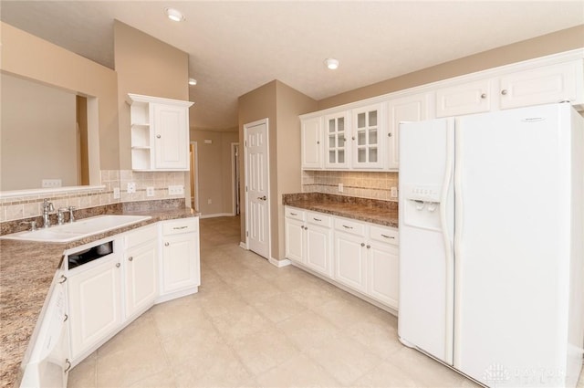 kitchen with decorative backsplash, white appliances, white cabinetry, and sink