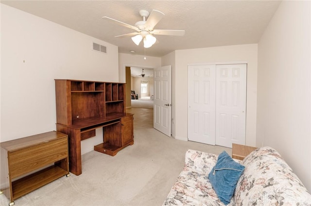 carpeted home office featuring ceiling fan