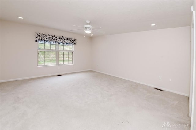 unfurnished room featuring light colored carpet and ceiling fan