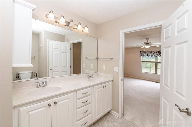 bathroom with vanity, a textured ceiling, ceiling fan, tile patterned flooring, and toilet