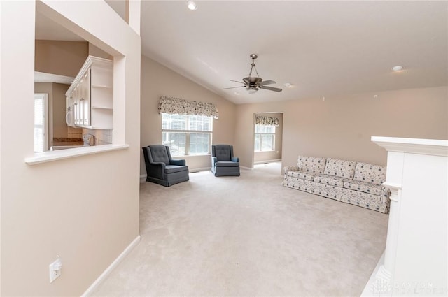 unfurnished living room with light carpet, ceiling fan, and lofted ceiling