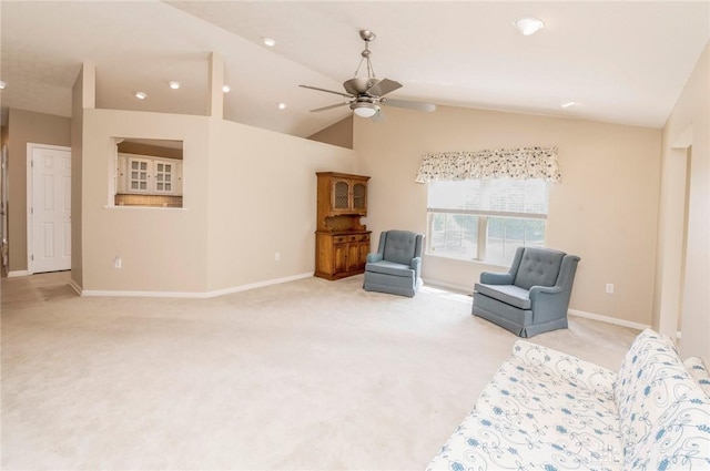 sitting room with ceiling fan, light colored carpet, and lofted ceiling