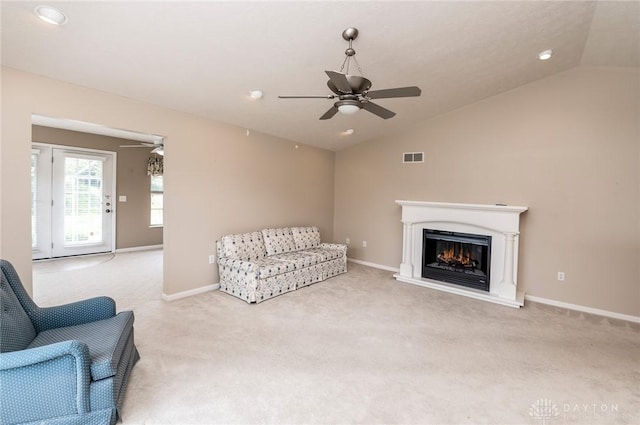 carpeted living room featuring vaulted ceiling and ceiling fan