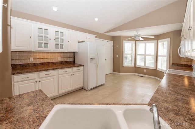 kitchen with backsplash, white appliances, ceiling fan, white cabinets, and lofted ceiling